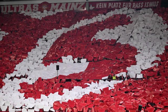 Mainz fans cheer for their team ahead of the UEFA Europa Conference League quarter-final first leg football match between 1 FSV Mainz 05 and RC Strasbourg Alsace in Mainz, western Germany on April 9, 2026. (Photo by Kirill KUDRYAVTSEV / AFP)