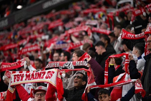Mainz fans cheer for their team ahead of the UEFA Europa Conference League quarter-final first leg football match between 1 FSV Mainz 05 and RC Strasbourg Alsace in Mainz, western Germany on April 9, 2026. (Photo by Kirill KUDRYAVTSEV / AFP)
