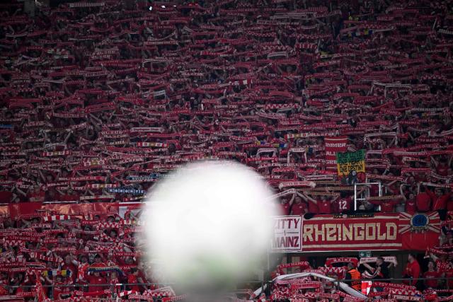 Mainz fans cheer for their team ahead of the UEFA Europa Conference League quarter-final first leg football match between 1 FSV Mainz 05 and RC Strasbourg Alsace in Mainz, western Germany on April 9, 2026. (Photo by Kirill KUDRYAVTSEV / AFP)