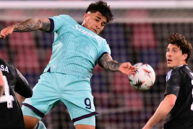 Bologna's Argentine forward #09 Santiago Castro fights for the ball with Aston Villa's Spanish defender #14 Pau Torres during the UEFA Europa League quarter final first leg football match between Bologna and Aston Villa at the Renato Dall'Ara stadium in Bologna on April 9, 2026. (Photo by Stefano RELLANDINI / AFP)