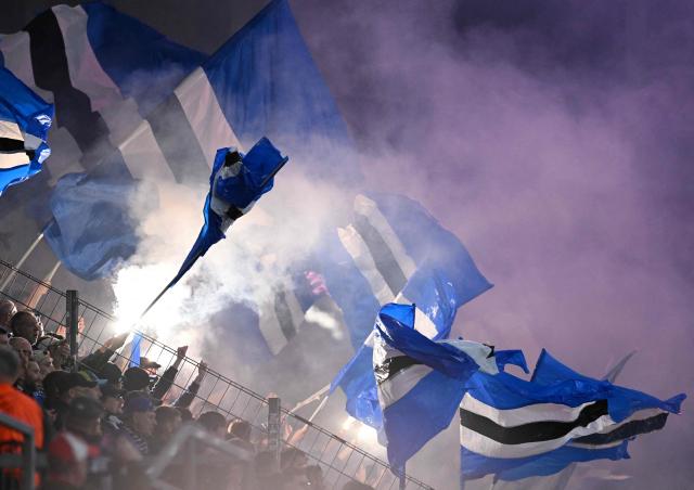 Fans of Strasbourg wave flags during the UEFA Europa Conference League quarter-final first leg football match between 1 FSV Mainz 05 and RC Strasbourg Alsace in Mainz, western Germany on April 9, 2026. (Photo by Kirill KUDRYAVTSEV / AFP)