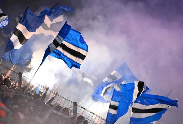 Fans of Strasbourg wave flags during the UEFA Europa Conference League quarter-final first leg football match between 1 FSV Mainz 05 and RC Strasbourg Alsace in Mainz, western Germany on April 9, 2026. (Photo by Kirill KUDRYAVTSEV / AFP)
