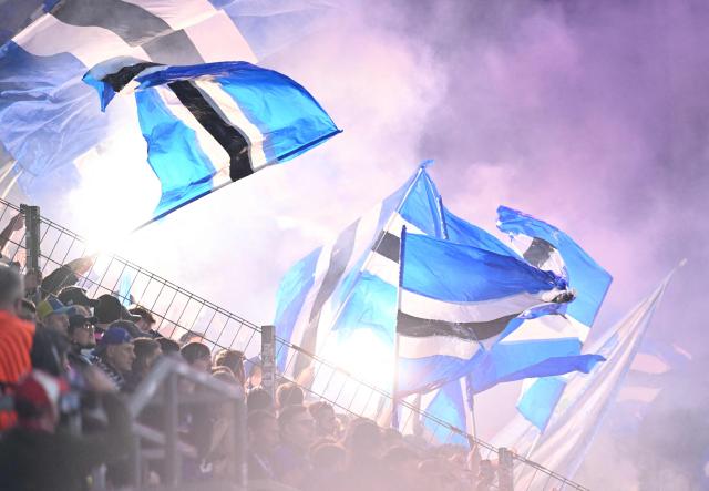 Fans of Strasbourg wave flags during the UEFA Europa Conference League quarter-final first leg football match between 1 FSV Mainz 05 and RC Strasbourg Alsace in Mainz, western Germany on April 9, 2026. (Photo by Kirill KUDRYAVTSEV / AFP)