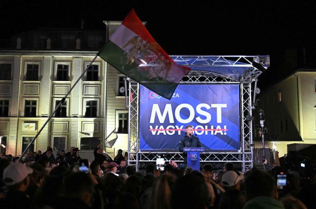 Hungarian opposition leader, head of the TISZA party and candidate for Hungarian Prime Minister Peter Magyar addresses supporters backdropped by a banner reading "Now or Never" on April 9, 2026 at a campaign rally in Gyor, during his nationwide tour ahead of the April 12 election. (Photo by Attila KISBENEDEK / AFP)