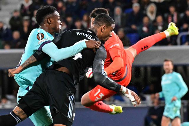 Aston Villa's English defender  #04 Ezri Konsa scores his team's first goal against Bologna's Italian goalkeeper #13 Federico Ravaglia during the UEFA Europa League quarter final first leg football match between Bologna and Aston Villa at the Renato Dall'Ara stadium in Bologna on April 9, 2026. (Photo by Stefano RELLANDINI / AFP)
