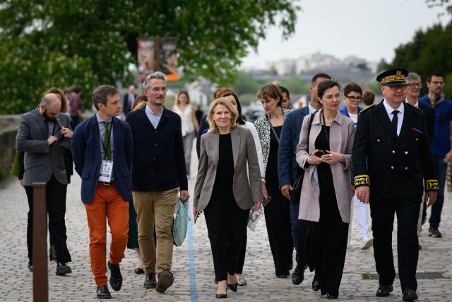 French Culture Minister Catherine Pégard (C) arrives for the inauguration of a gallery designed by Japanese architect Kengo Kuma to protect the portal of Saint-Maurice Cathedral, in Angers, western France, on April 9, 2026. (Photo by Loic VENANCE / AFP)