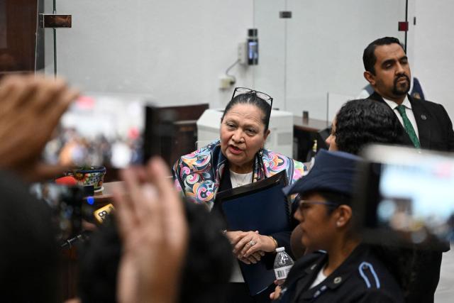Guatemala's attorney general Consuelo Porras (C) speaks to journalists following a meeting of the commission that nominates finalists for the election of the attorney general for the next four-year term at the Supreme Court in Guatemala City on April 9, 2026. (Photo by JOHAN ORDONEZ / AFP)