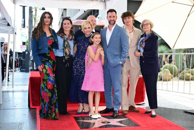 US actor Noah Wyle (3R) with his parents Stephen Wyle (4R) and Marty Wyle (R), his wife actress Sara Wells (3L) his chidren Auden Wyle (L), Frances Harper Wyle (4R) and Owen Strausser Wyle (2R) and his sister Alex Wyle (2L) stand on his star during his Walk of Fame ceremony in Hollywood, California on April 9, 2026. (Photo by Frederic J. BROWN / AFP)