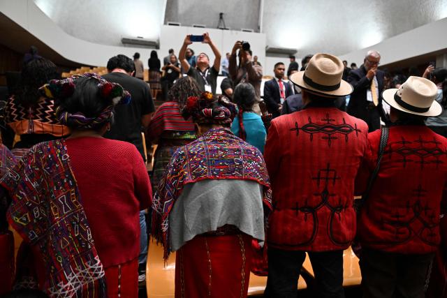 Attendees stand up and turn their backs in protest during a meeting of Guatemala's attorney general Consuelo Porras with the commission that nominates finalists for the election of the attorney general for the next four-year term at the Supreme Court in Guatemala City on April 9, 2026. (Photo by JOHAN ORDONEZ / AFP)
