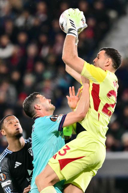 Aston Villa's Argentinian goalkeeper #23 Emiliano Martínez makes a save in front of Bologna's Swiss midfielder #08 Remo Freuler during the UEFA Europa League quarter final first leg football match between Bologna and Aston Villa at the Renato Dall'Ara stadium in Bologna on April 9, 2026. (Photo by Stefano RELLANDINI / AFP)