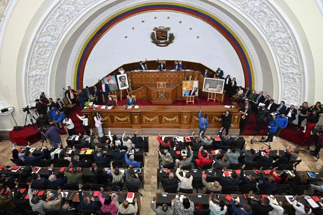 (FILES) Lawmakers of Venezuela's National Assembly vote during a debate on an amnesty bill proposed by Venezuela's interim president Delcy Rodriguez at the National Assembly in Caracas on February 19, 2026. Venezuela's Parliament approved a mining law that opens the door for foreign investors to exploit the country's vast reserves on April 9, 2026, following a similar move regarding the oil industry under pressure from the United States. (Photo by Federico PARRA / AFP)