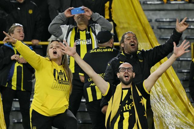 Fans of Penarol cheer for their team before the Copa Libertadores group stage football match between Colombia's Independiente Santa Fe and Uruguay's Penarol at the Nemesio Camacho El Campin stadium in Bogota, on April 9, 2026. (Photo by Luis ACOSTA / AFP)
