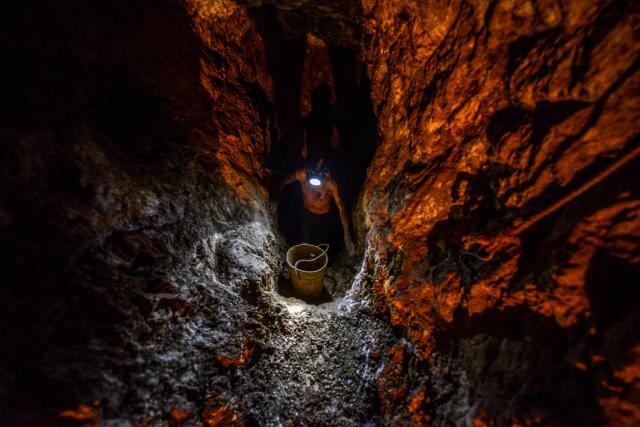 (FILES) Ender Moreno looks for gold at La Culebra gold mine in El Callao, Bolivar state, southeastern Venezuela on March 1, 2017. Venezuela's Parliament approved a mining law that opens the door for foreign investors to exploit the country's vast reserves on April 9, 2026, following a similar move regarding the oil industry under pressure from the United States. (Photo by JUAN BARRETO / AFP)