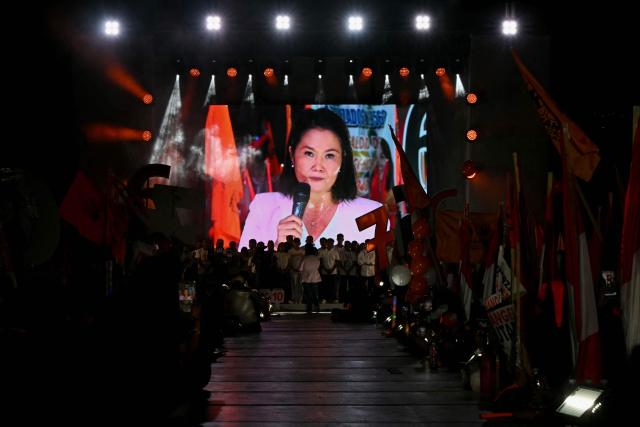 Peru's presidential candidate Keiko Fujimori, for the Fuerza Popular party, is seen on a giant screen as she speaks to supporters during her closing campaign rally at Villa el Salvador in Lima on April 9, 2026. Peru will hold presidential elections on April 12. (Photo by ERNESTO BENAVIDES / AFP)