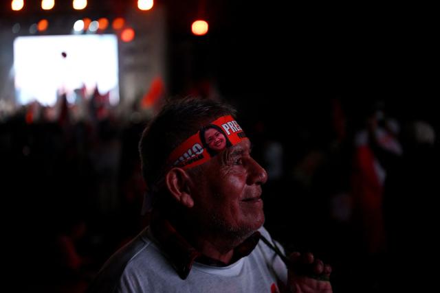 A supporter of Peru's presidential candidate Keiko Fujimori, for the Fuerza Popular party, looks on during her closing campaign rally at Villa el Salvador in Lima on April 9, 2026. Peru will hold presidential elections on April 12. (Photo by ERNESTO BENAVIDES / AFP)