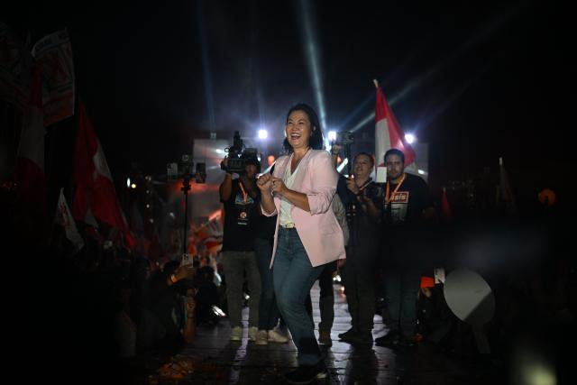 Peru's presidential candidate Keiko Fujimori, for the Fuerza Popular party, dances during her closing campaign rally at Villa el Salvador in Lima on April 9, 2026. Peru will hold presidential elections on April 12. (Photo by ERNESTO BENAVIDES / AFP)