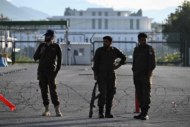 Pakistani police officers stand guard near the President House in the Red Zone area in Islamabad on April 10, 2026. Pakistan has been preparing for high-stakes talks involving US and Iranian representatives over the war in the Middle East, with the White House saying Vice President JD Vance will be leading a team to the negotiations in Islamabad "this weekend". (Photo by Aamir QURESHI / AFP)