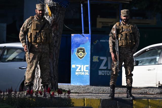 Pakistani soldiers stand guard at a cordon on a street near the President House in the Red Zone area in Islamabad on April 10, 2026. Pakistan has been preparing for high-stakes talks involving US and Iranian representatives over the war in the Middle East, with the White House saying Vice President JD Vance will be leading a team to the negotiations in Islamabad "this weekend". (Photo by Aamir QURESHI / AFP)
