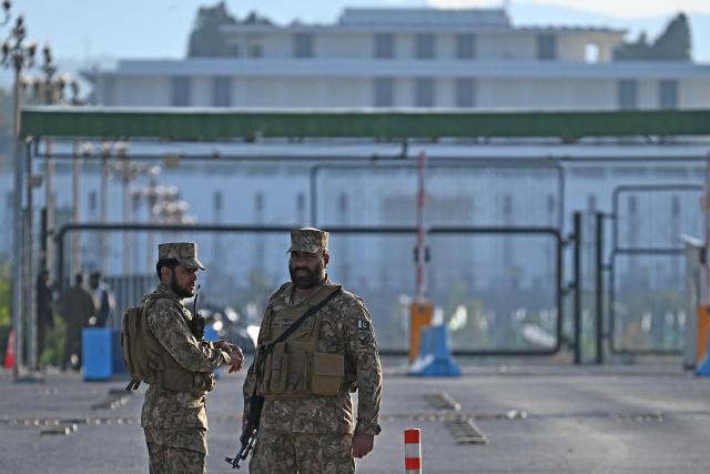 Pakistani soldiers stand guard near the President House in the Red Zone area in Islamabad on April 10, 2026. Pakistan has been preparing for high-stakes talks involving US and Iranian representatives over the war in the Middle East, with the White House saying Vice President JD Vance will be leading a team to the negotiations in Islamabad "this weekend". (Photo by Aamir QURESHI / AFP)