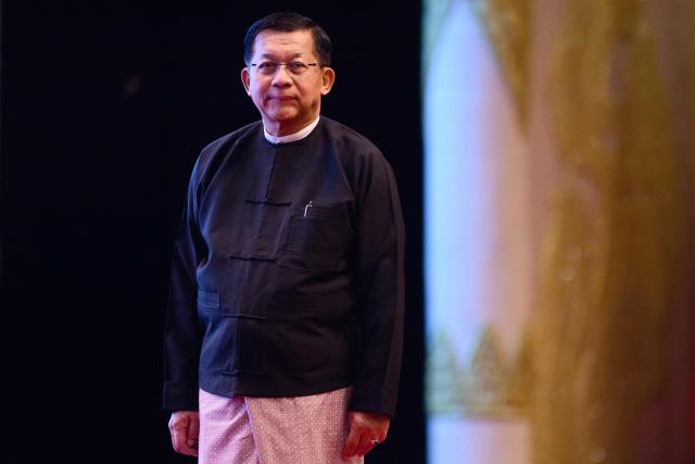 (FILES) Military Chief Min Aung Hlaing looks on after delivering a speech during a memorial event at the Myanmar International Convention Centre (MICC) in Naypyidaw on March 28, 2026, to mark the first anniversary since a 7.7-magnitude tremor struck, killing more than 3,800 people in Myanmar -- and around 90 more in neighbouring Thailand. Myanmar junta chief Min Aung Hlaing was sworn in as president on April 10, 2026, AFP journalists saw, continuing his rule from a civilian post five years after snatching power in a coup. (Photo by ANTHONY WALLACE / AFP)