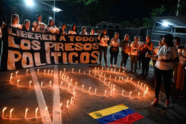 People hold a vigil demanding the release of Venezuelan political prisoners in front of El Rodeo I prison in Guatire, Miranda state, Venezuela on April 9, 2026. (Photo by Maryorin Mendez / AFP)