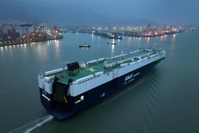 This aerial photo taken on April 9, 2026 shows a cargo ship moving to a berth at a port in Lianyungang, China's Jiangsu province. (Photo by CN-STR / AFP) / China OUT