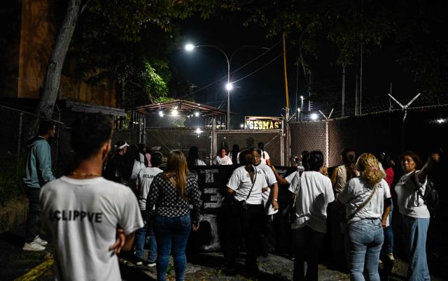 People hold a vigil demanding the release of Venezuelan political prisoners in front of El Rodeo I prison in Guatire, Miranda state, Venezuela on April 9, 2026. (Photo by Maryorin Mendez / AFP)