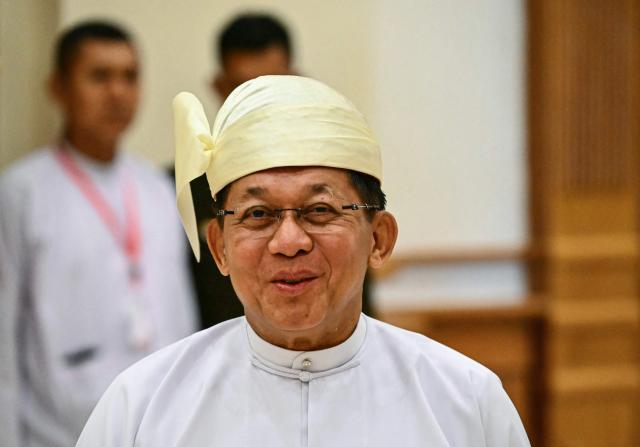 Former Myanmar military chief and Myanmar president Min Aung Hlaing leaves after his sworn-in ceremony during a session of the Pyidaungsu Hluttaw (Union Parliament) in Naypyidaw on April 10, 2026. Myanmar junta chief Min Aung Hlaing was sworn in as president on April 10, 2026, AFP journalists saw, continuing his rule from a civilian post five years after snatching power in a coup. (Photo by Sai Aung MAIN / AFP)