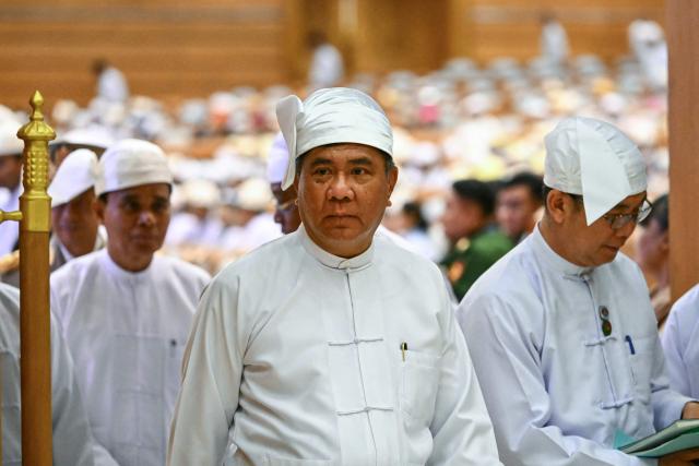 Members of Myanmar's parliament leave after the sworn-in ceremony for Myanmar president during a session of the Pyidaungsu Hluttaw (Union Parliament) in Naypyidaw on April 10, 2026. Myanmar junta chief Min Aung Hlaing was sworn in as president on April 10, 2026, AFP journalists saw, continuing his rule from a civilian post five years after snatching power in a coup. (Photo by Sai Aung MAIN / AFP)