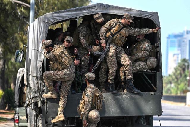 Pakistani army soldiers arrive for deployment at the Red Zone area of Islamabad on April 10, 2026. As Iranian and US envoys prepare to hold talks in Islamabad to end the Middle East war, official sources and experts say Beijing helped pave the way for the negotiations and will be a crucial component in securing a permanent truce. (Photo by Aamir QURESHI / AFP)