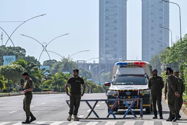 Security personnel keep watch along the cordon street near the expected venue of the US-Iran talks in the Red Zone area of Islamabad on April 10, 2026. As Iranian and US envoys prepare to hold talks in Islamabad to end the Middle East war, official sources and experts say Beijing helped pave the way for the negotiations and will be a crucial component in securing a permanent truce. (Photo by Aamir QURESHI / AFP)