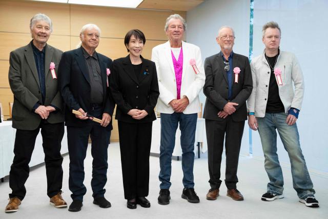 Japan’s Prime Minister Sanae Takaichi (3rd L) poses with members of British rock band Deep Purple Don Airey (L), Ian Paice (2nd L), Ian Gillan (3rd R), Roger Glover (2nd R) and Simon McBrideat (R) during their meeting the Prime Minister's Office in Tokyo on April 10, 2026. (Photo by Yuichi YAMAZAKI / POOL / AFP)