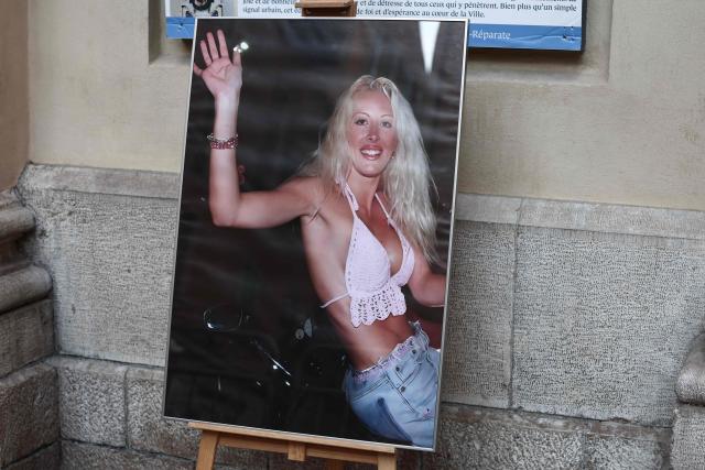 This photograph depicts the first TV reality show star Loana Petrucciani waving to fans onboard a car on the Grande Armee avenue on July 5, 2001 on the last evening on the Loft Story TV broadcast, displayed ahead of her funeral ceremony in front of the church of Sainte-Reparate in Nice, southeastern France where she was found dead at her home at the age of 48, on April 10, 2026. (Photo by Thibaud MORITZ / AFP)