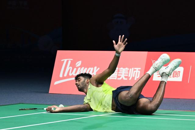 India's Ayush Shetty fells down during the men's singles quarter final match against  Indonesia's Jonatan Christie at the Badminton Asia Championship in Ningbo, eastern China's Zhejiang province on April 10, 2026. (Photo by CN-STR / AFP) / China OUT