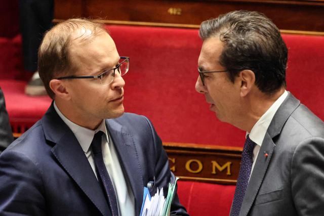 Droite Republicaine's MP Thibault Bazin (L) speaks with France's Labour Minister Jean-Pierre Farandou during a debate at the National Assembly, French Parliament lower house, to discuss a proposed low aiming to authorise the work of employees of certain businesses on May 1st, in Paris on April 10, 2026. (Photo by Ludovic MARIN / AFP)