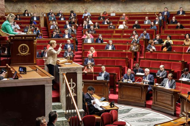 Ecologiste et Social's MP Clementine Autain (L) speaks while French MPs attend a debate at the National Assembly, French Parliament lower house, to discuss a proposed low aiming to authorise the work of employees of certain businesses on May 1st, in Paris on April 10, 2026. (Photo by Ludovic MARIN / AFP)