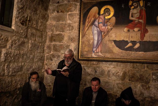 Orthodox Christian followers gather at the first station of the cross during the Good Friday procession in the Old City of Jerusalem on April 10, 2026. Christian pilgrims are in the Holy City to mark Good Friday and pray along the traditional route Jesus Christ took to his crucifixion, leading up to his resurrection on Easter Sunday. (Photo by JOHN WESSELS / AFP)