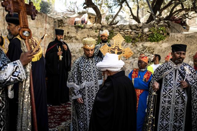Ethiopian Orthodox Christian priests gather during the Good Friday procession in the Old City of Jerusalem on April 10, 2026. Christian pilgrims are in the Holy City to mark Good Friday and pray along the traditional route Jesus Christ took to his crucifixion, leading up to his resurrection on Easter Sunday. (Photo by JOHN WESSELS / AFP)
