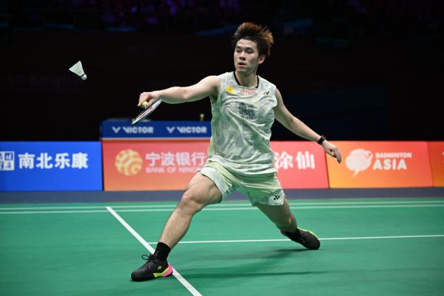 Thailand's Kunlavut Vitidsarn hits a return to China's Weng Hongyang during their men's singles quarter final match at the Badminton Asia Championship in Ningbo, eastern China's Zhejiang province on April 10, 2026. (Photo by CN-STR / AFP) / China OUT