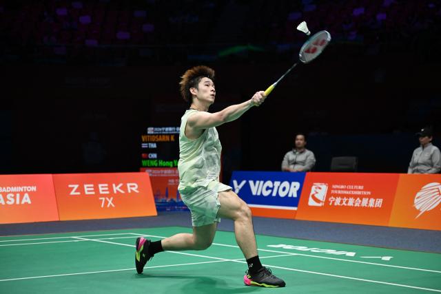 Thailand's Kunlavut Vitidsarn hits a return to China's Weng Hongyang during their men's singles quarter final match at the Badminton Asia Championship in Ningbo, eastern China's Zhejiang province on April 10, 2026. (Photo by CN-STR / AFP) / China OUT