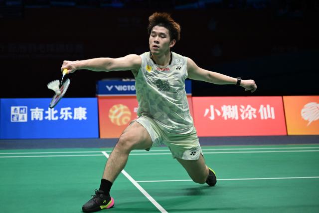 Thailand's Kunlavut Vitidsarn hits a return to China's Weng Hongyang during their men's singles quarter final match at the Badminton Asia Championship in Ningbo, eastern China's Zhejiang province on April 10, 2026. (Photo by CN-STR / AFP) / China OUT