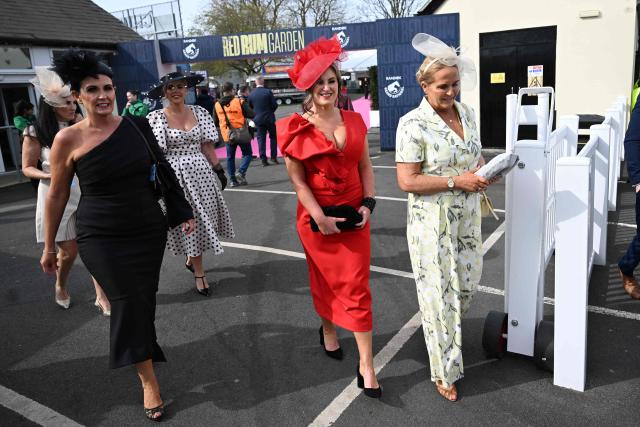 Racegoers arrive on Ladies Day, day two of the Grand National Festival horse race meeting at Aintree Racecourse in Liverpool, north-west England, on April 10, 2026. (Photo by Paul ELLIS / AFP)