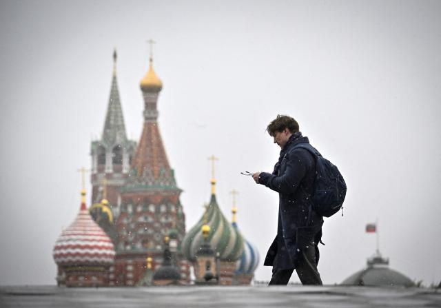 A man walks in front of St. Basil's cathedral in downtown Moscow on April 10, 2026. (Photo by Alexander NEMENOV / AFP)