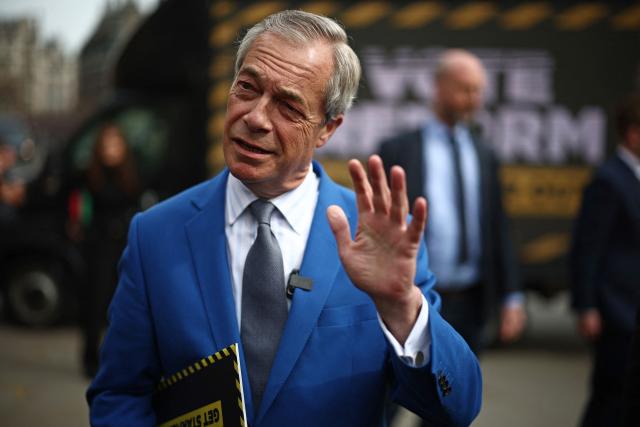 Reform UK leader Nigel Farage speaks to members of the media at a photo shoot to publicise a slogan ahead of the local elections in May, in central London on April 10, 2026. (Photo by Henry Nicholls / AFP)