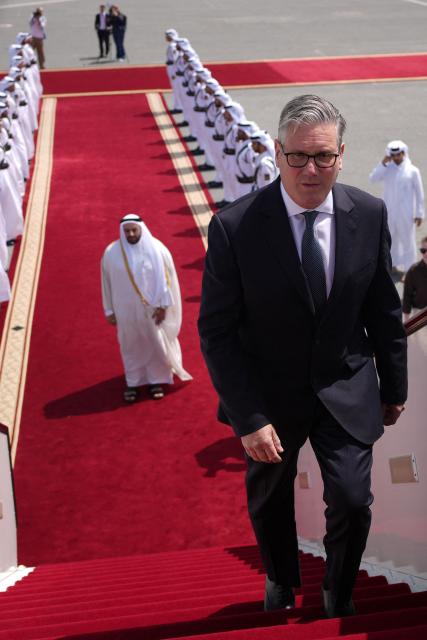 Britain's Prime Minister Keir Starmer boards his plane at the airport in Doha, Qatar on April 10, 2026. (Photo by Alastair Grant / POOL / AFP)