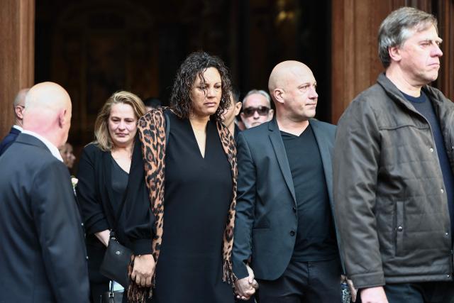 Loft Story ex-competitor Julie Mercy (C) leaves after attending the funeral ceremony of Loana Petrucciani, the first reality TV star in France, at the cathedral of Sainte-Reparate in Nice, southeastern France where she was found dead at her home at the age of 48, on April 10, 2026. (Photo by Thibaud MORITZ / AFP)