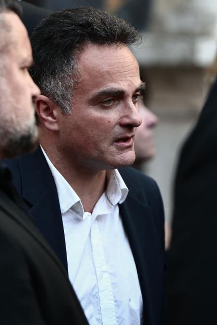 Laurent Amar (C), friend of Loana, and Frederic Garnier (L)  leave after attending the funeral ceremony of Loana Petrucciani, the first reality TV star in France, at the cathedral of Sainte-Reparate in Nice, southeastern France where she was found dead at her home at the age of 48, on April 10, 2026. (Photo by Thibaud MORITZ / AFP)