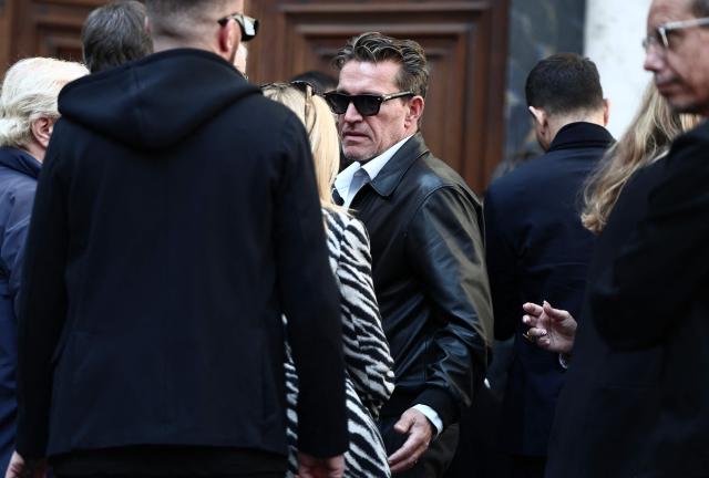 French TV host Benjamin Castaldi (C) leaves after attending the funeral ceremony of Loana Petrucciani, the first reality TV star in France, at the cathedral of Sainte-Reparate in Nice, southeastern France where she was found dead at her home at the age of 48, on April 10, 2026. (Photo by Thibaud MORITZ / AFP)