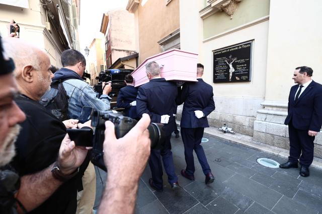 Photographers take images of the coffin of Loana Petrucciani, the first reality TV star in France, leaving the cathedral of Sainte-Reparate at the end of her funeral ceremony in Nice, southeastern France where she was found dead at her home at the age of 48, on April 10, 2026. (Photo by Thibaud MORITZ / AFP)
