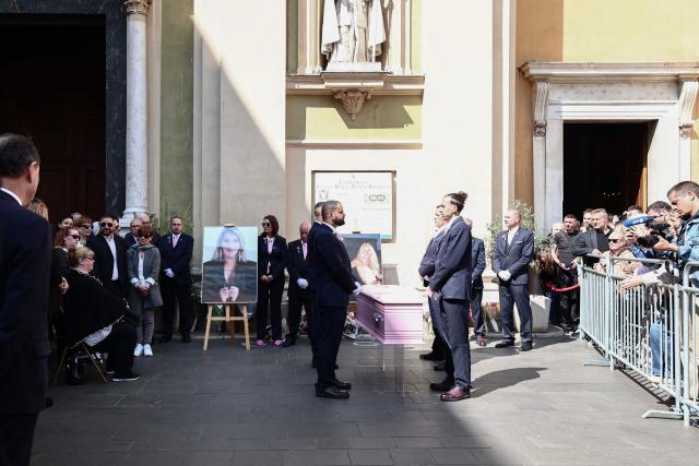TOPSHOT - Violette Petrucciani (L), mother of Loana, sits in front of the coffin and a photograph depicting Loana Petrucciani, the first reality TV star in France, as she attends her funeral ceremony at the cathedral of Sainte-Reparate in Nice, southeastern France where she was found dead at her home at the age of 48, on April 10, 2026. (Photo by Thibaud MORITZ / AFP)